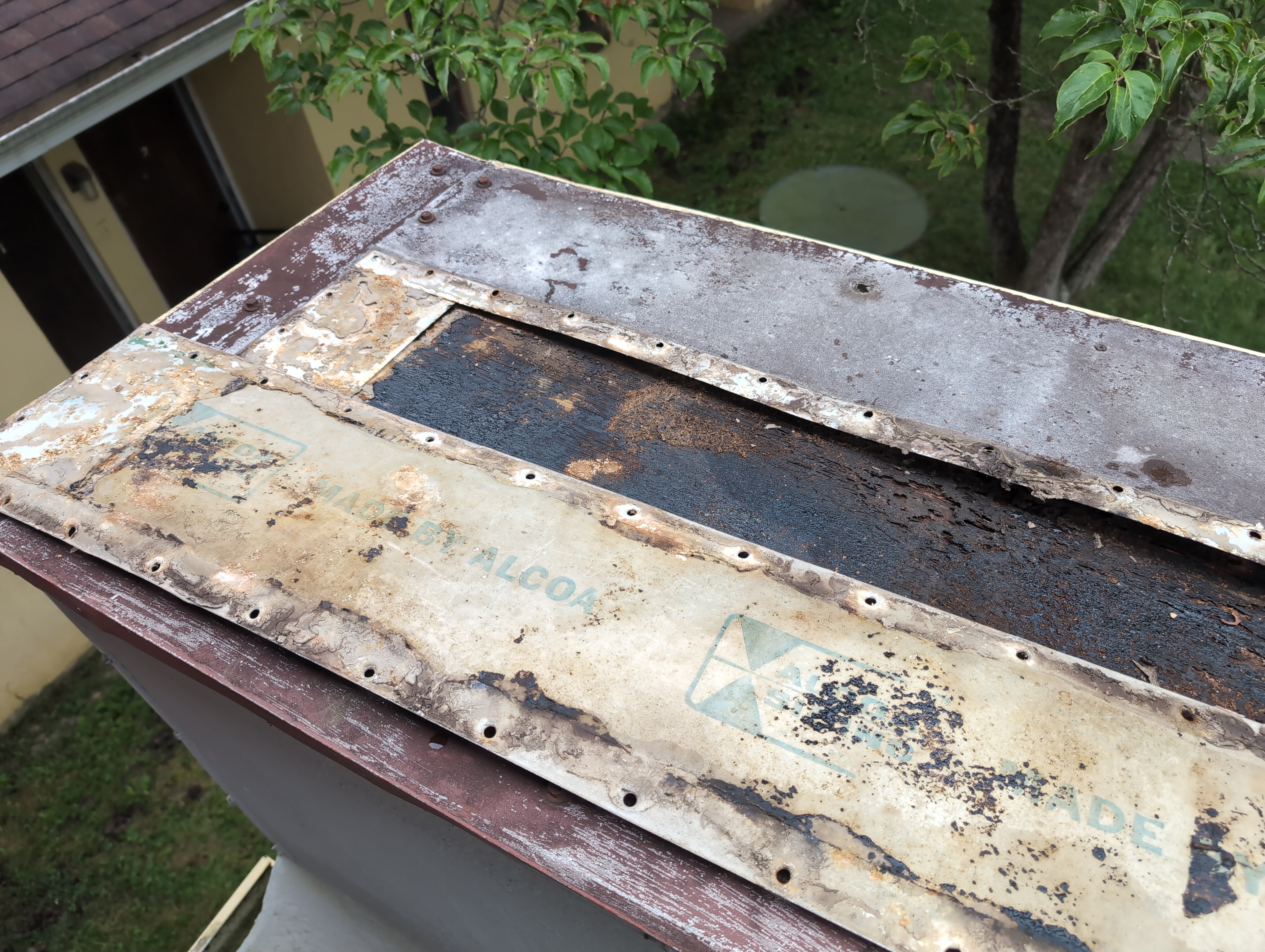 The center piece of metal has been pulled off. It's sitting face down on the roof. It has 