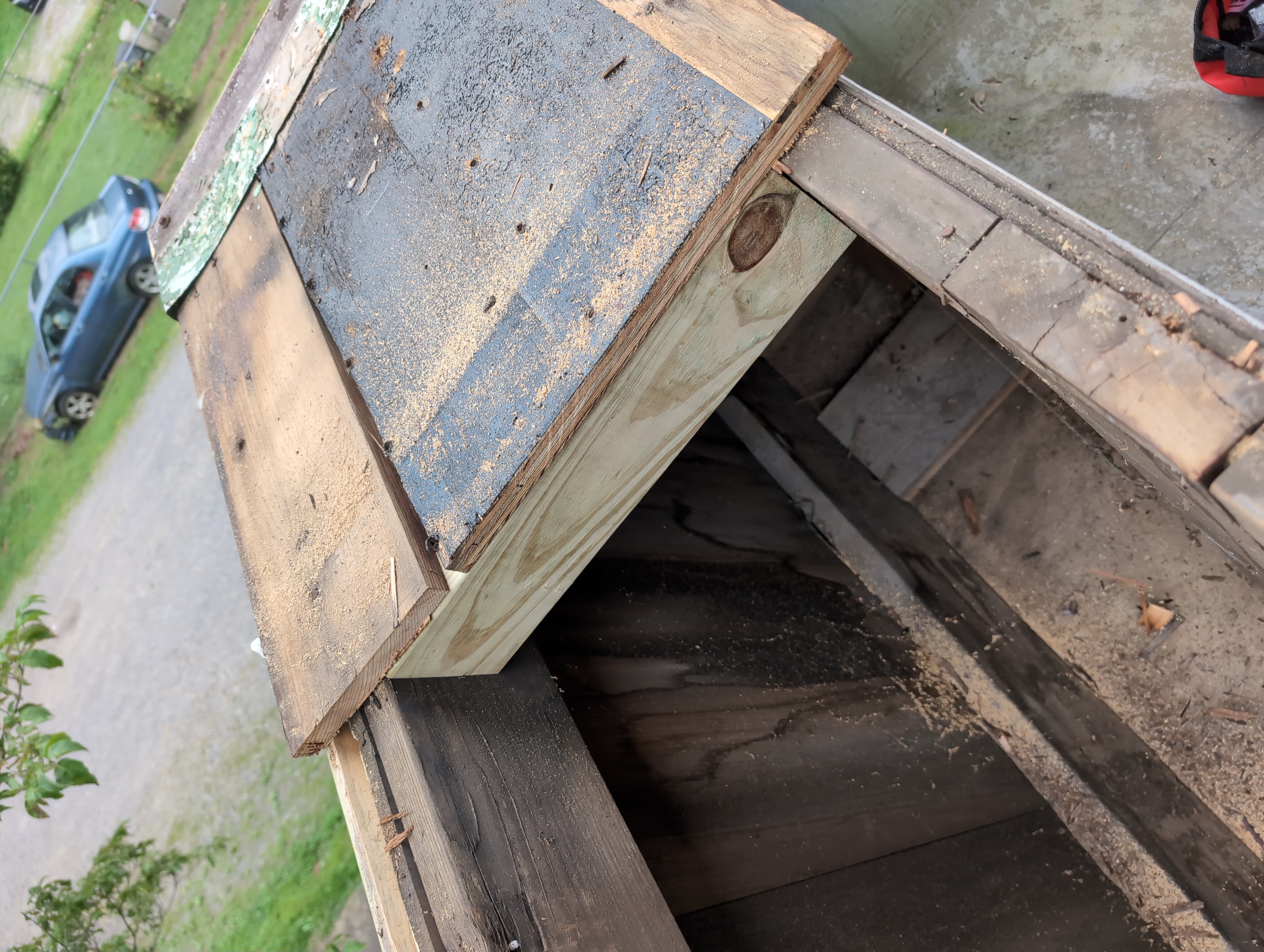 A fresh bit of 2x4 stuck across the space directly under what was left of the boards that were just cut down.