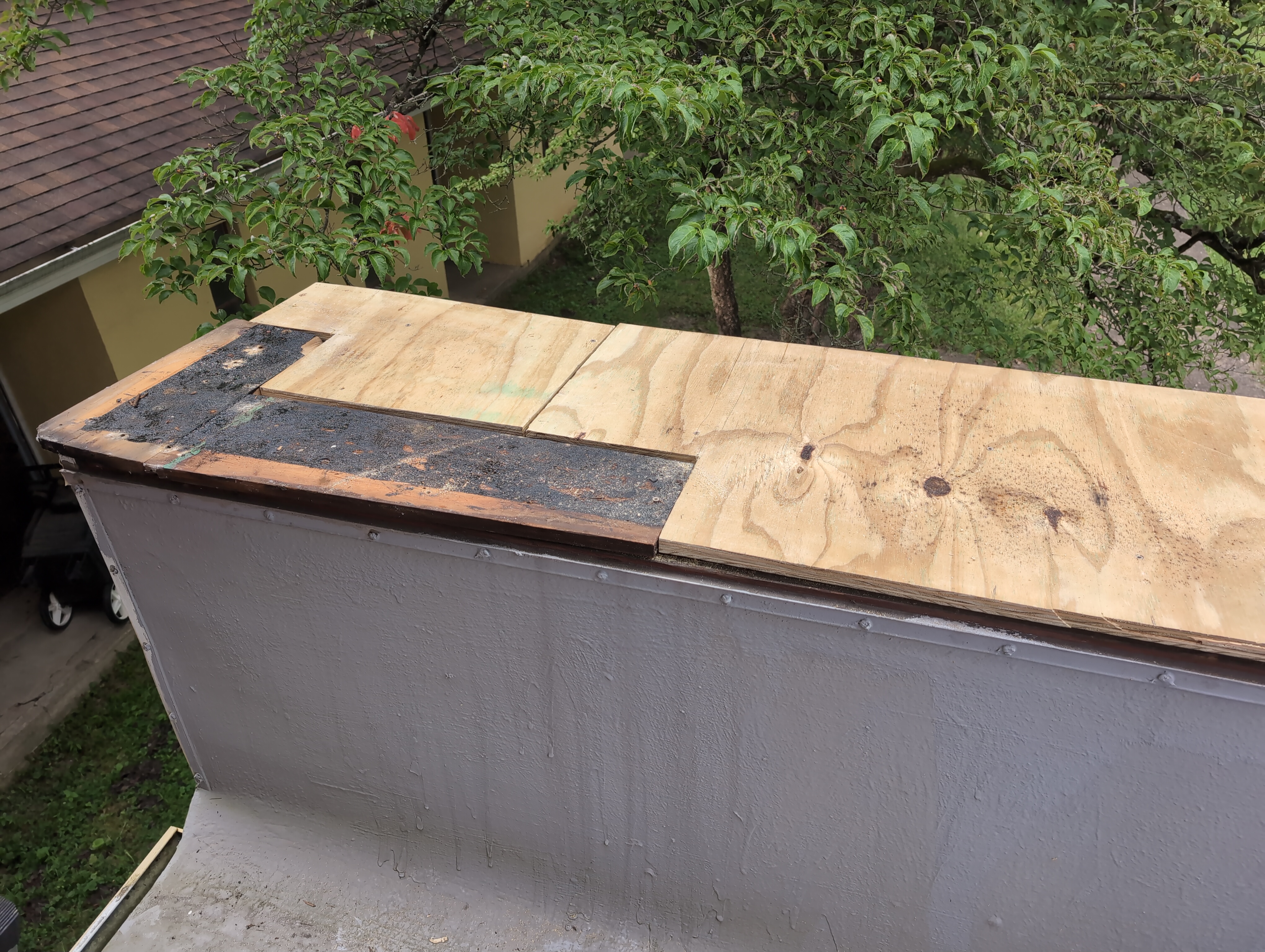 Fresh plywood puzzled into place around the existing darkened wood. The result approximates a full rectangle, I suppose.