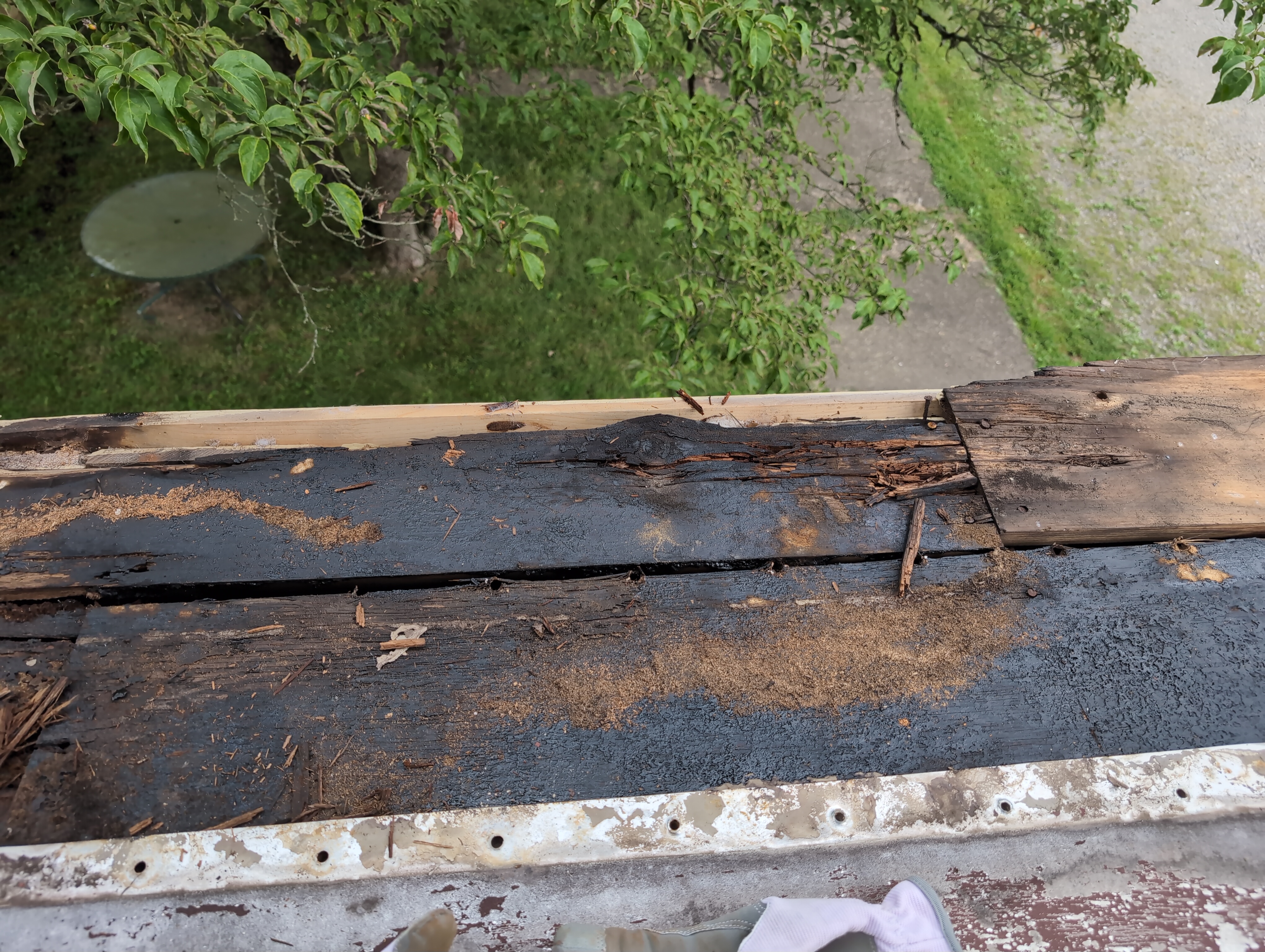 A section of crumbly looking wood at the far side of the roof
